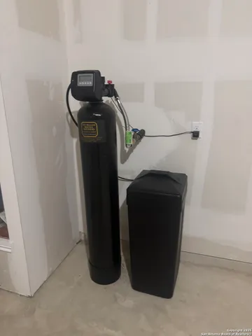 a view of a yard with a wooden fence