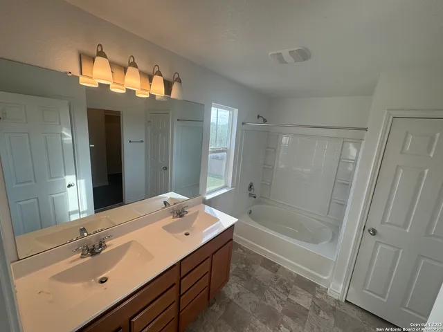 a black and white vase sitting on a blue wall