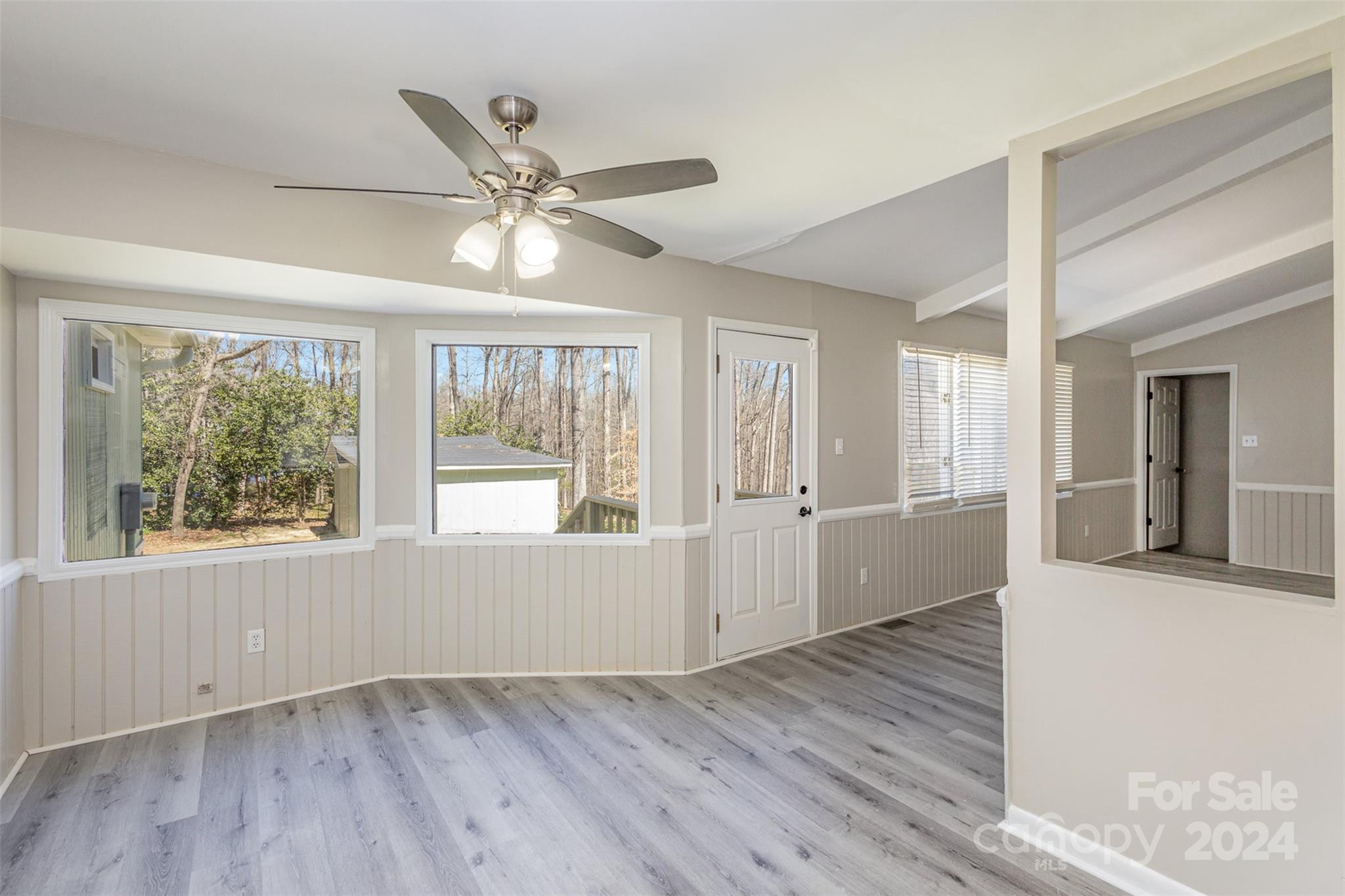 1704 Double Oaks Road Fort Mill, SC 29715 - Photo 11 of 48 a view of an empty room with wooden floor and a window