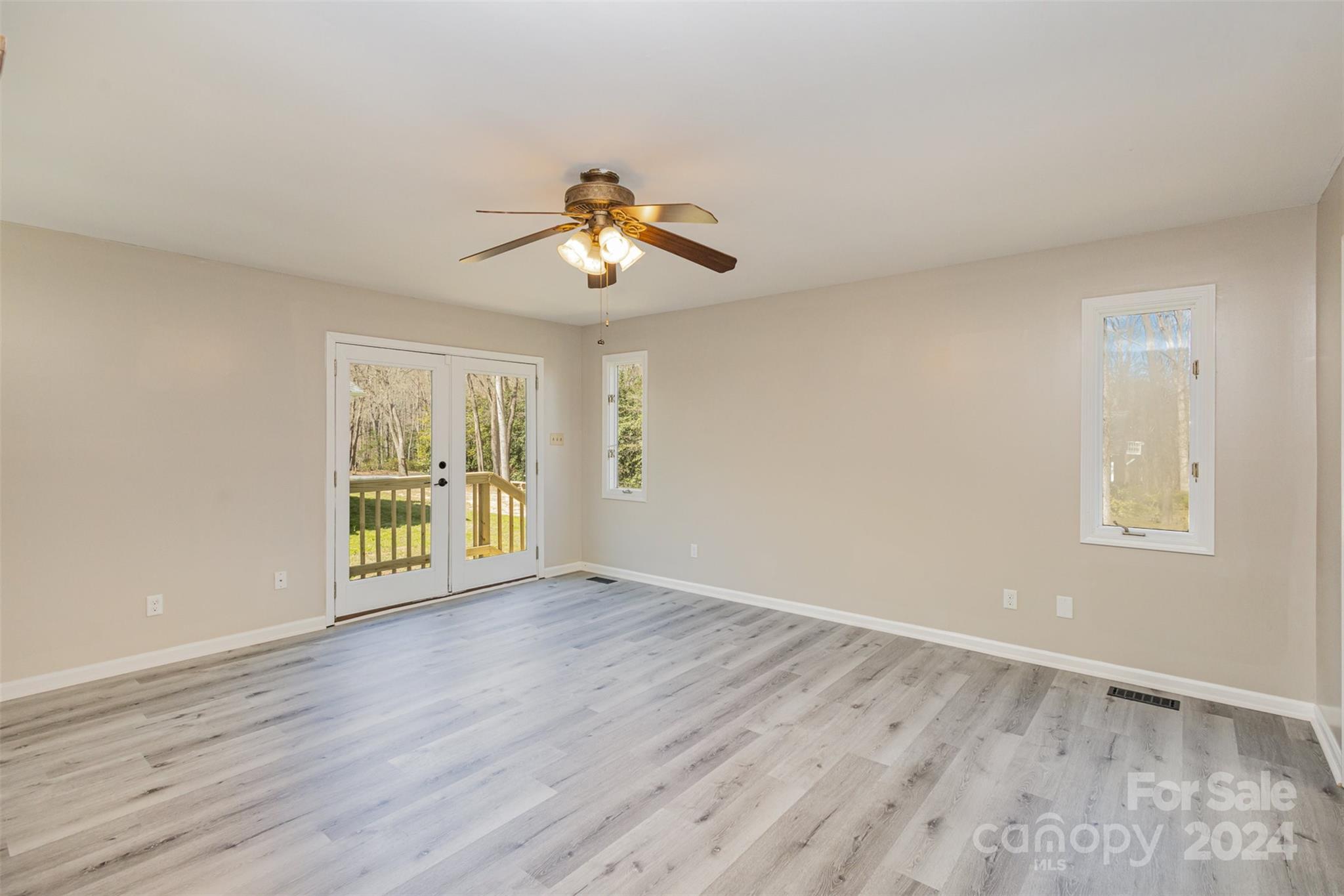 1704 Double Oaks Road Fort Mill, SC 29715 - Photo 18 of 48 a view of an empty room with a window and wooden floor