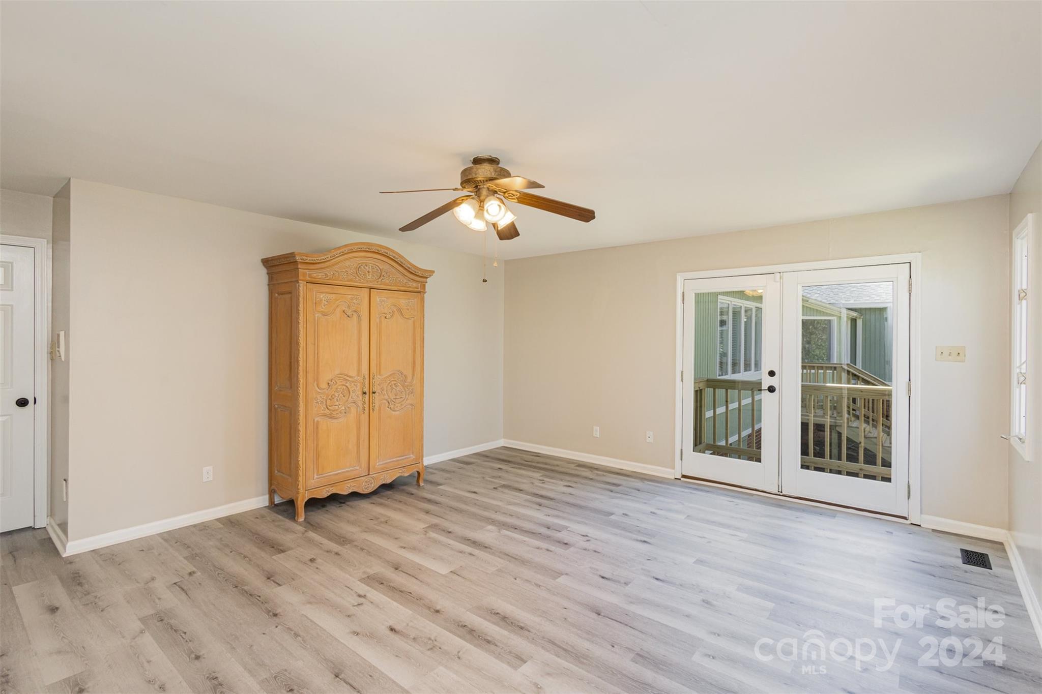 1704 Double Oaks Road Fort Mill, SC 29715 - Photo 21 of 48 a view of an empty room with wooden floor and a window