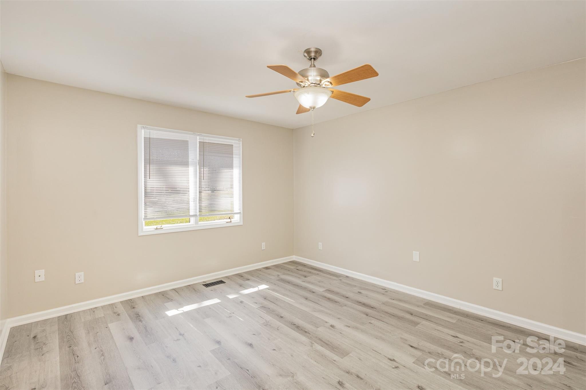 1704 Double Oaks Road Fort Mill, SC 29715 - Photo 23 of 48 wooden floor in an empty room with a window