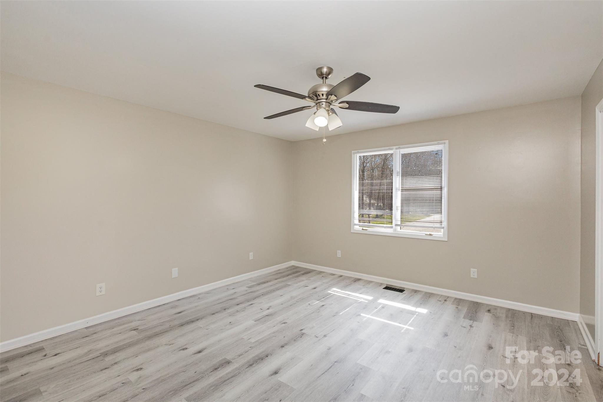1704 Double Oaks Road Fort Mill, SC 29715 - Photo 25 of 48 a view of empty room with wooden floor and fan
