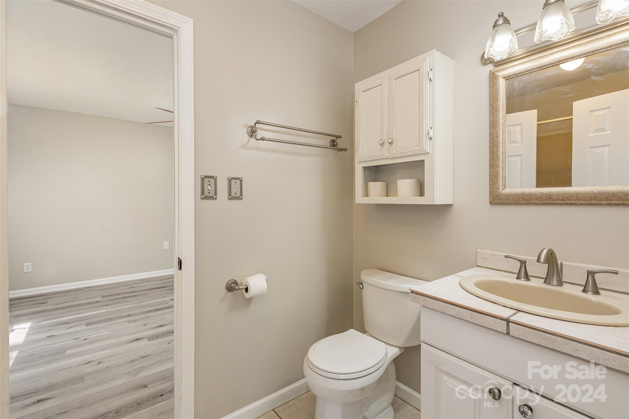 1704 Double Oaks Road Fort Mill, SC 29715 - Photo 27 of 48 a bathroom with a granite countertop sink toilet and shower