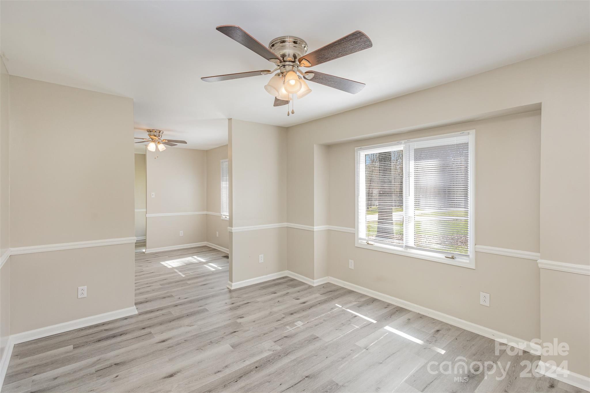 1704 Double Oaks Road Fort Mill, SC 29715 - Photo 3 of 48 a view of an empty room with wooden floor and a window
