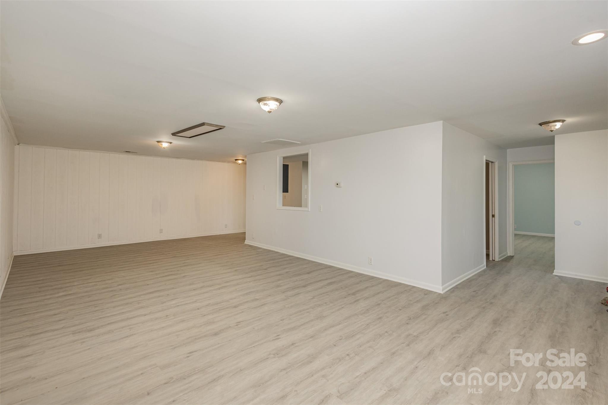 1704 Double Oaks Road Fort Mill, SC 29715 - Photo 31 of 48 an empty room with wooden floor and windows