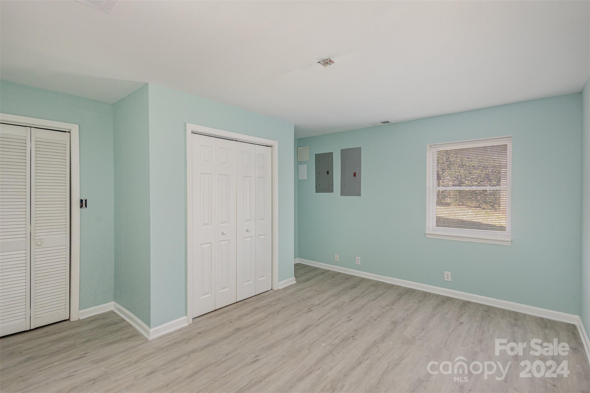 1704 Double Oaks Road Fort Mill, SC 29715 - Photo 36 of 48 a view of an empty room with wooden floor and a window