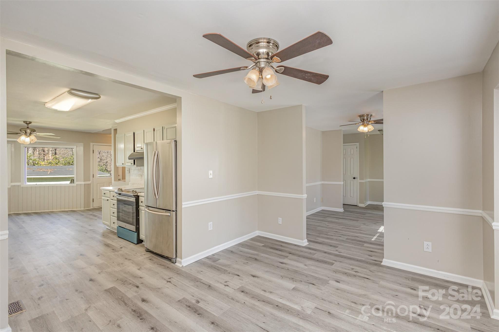 1704 Double Oaks Road Fort Mill, SC 29715 - Photo 4 of 48 a view of a livingroom with wooden floor and white cabinet