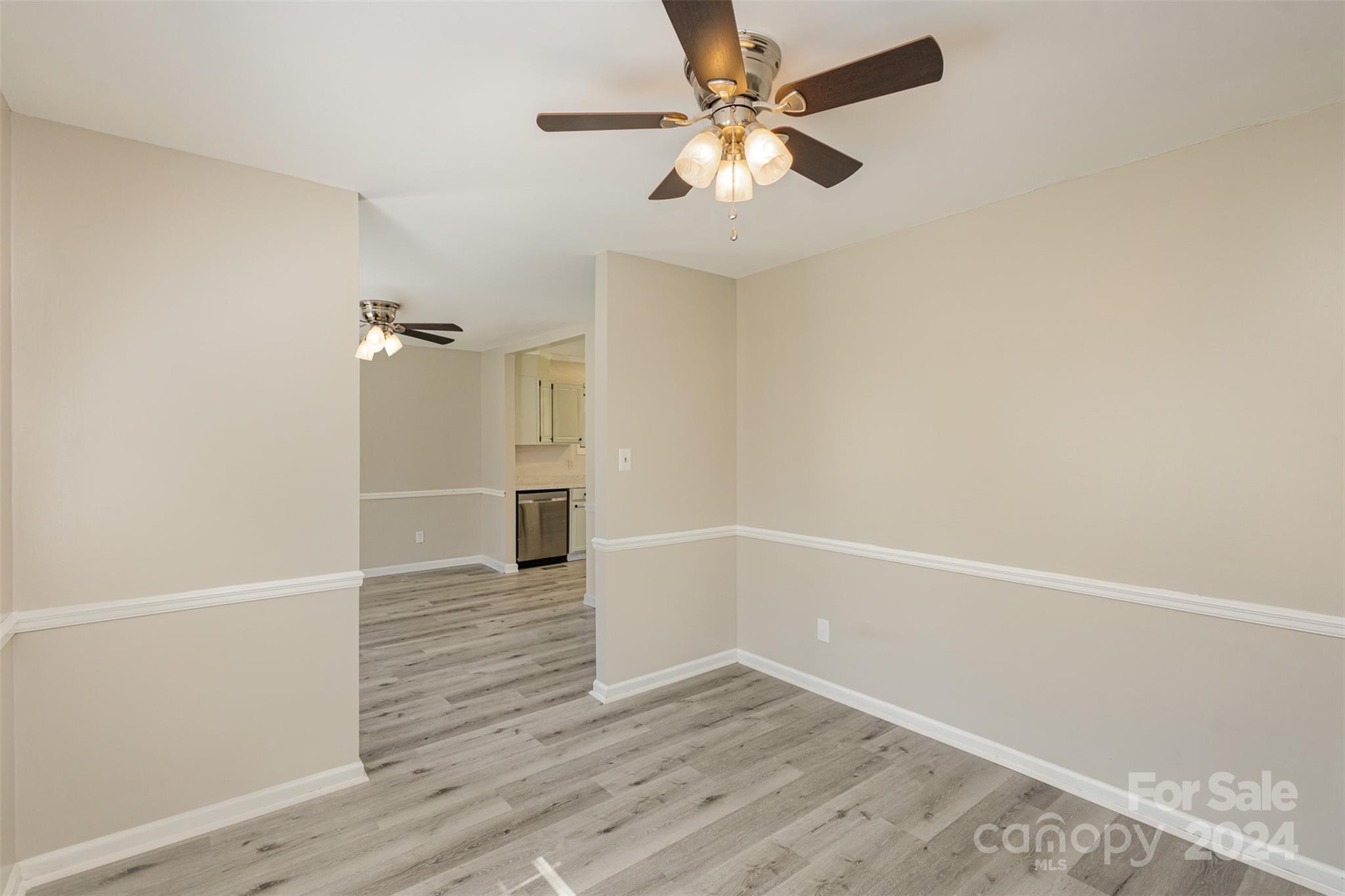 1704 Double Oaks Road Fort Mill, SC 29715 - Photo 7 of 48 an empty room with wooden floor fan and windows