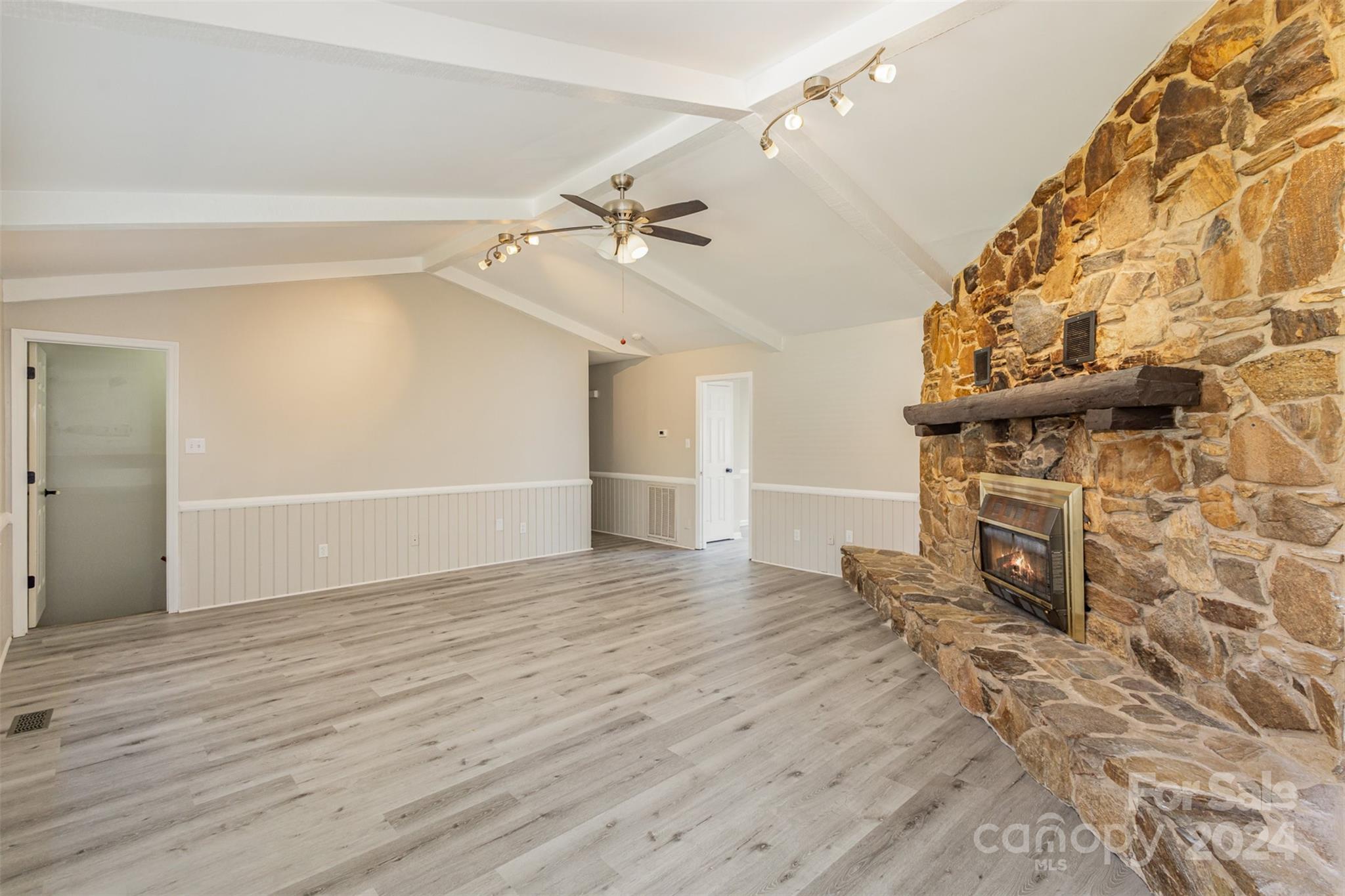 1704 Double Oaks Road Fort Mill, SC 29715 - Photo 9 of 48 a view of empty room with wooden floor and fan