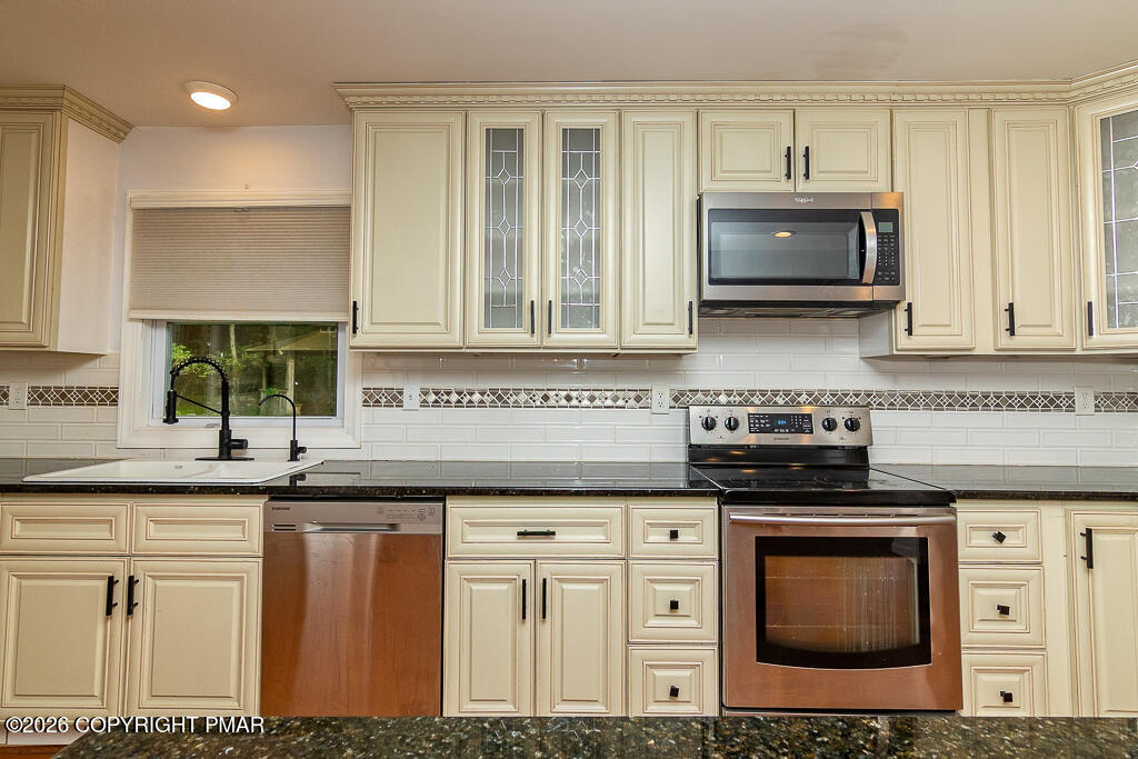 755 White Oak Road Cresco, PA 18326 - Photo 7 of 50 a kitchen with stainless steel appliances granite countertop a stove a sink and a microwave