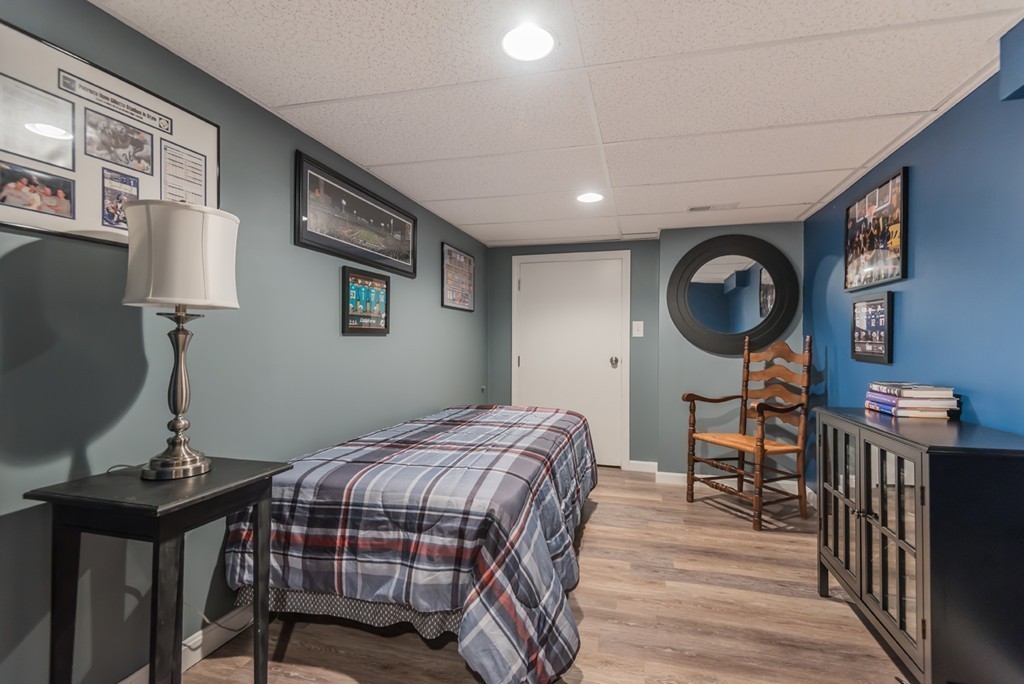 151 Killam Hill Road Boxford, MA 01921 - Photo 19 of 30 a bedroom with a bed and a mirror