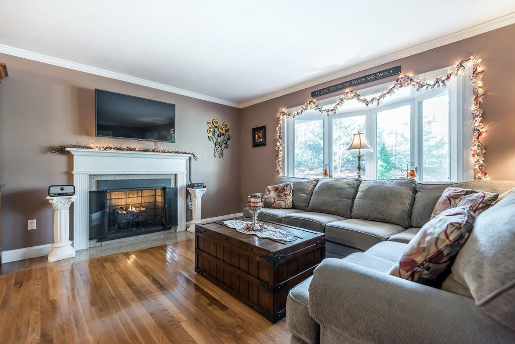 151 Killam Hill Road Boxford, MA 01921 - Photo 2 of 30 a living room with furniture a flat screen tv and a fireplace