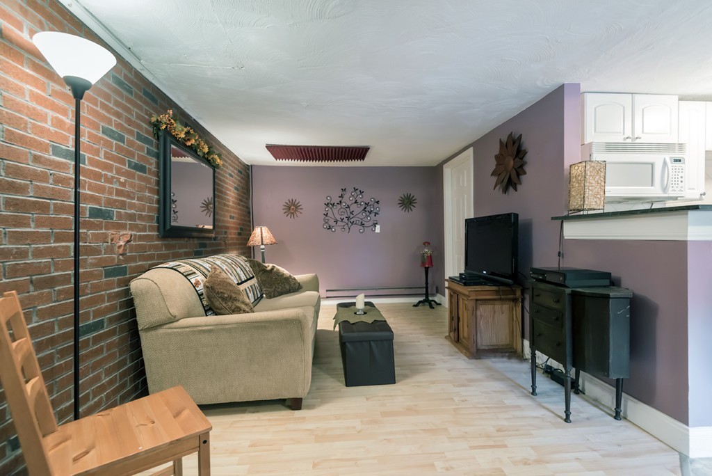 151 Killam Hill Road Boxford, MA 01921 - Photo 22 of 30 a living room with furniture and a flat screen tv