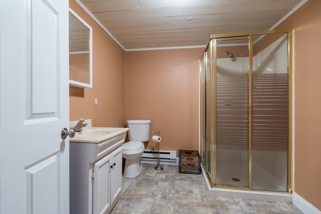 151 Killam Hill Road Boxford, MA 01921 - Photo 26 of 30 a bathroom with a sink mirror vanity and toilet