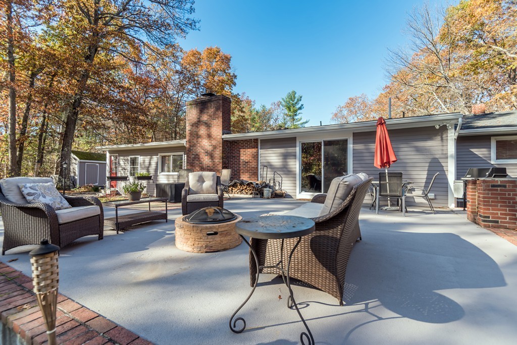 151 Killam Hill Road Boxford, MA 01921 - Photo 28 of 30 a backyard of a house with dining table and chairs