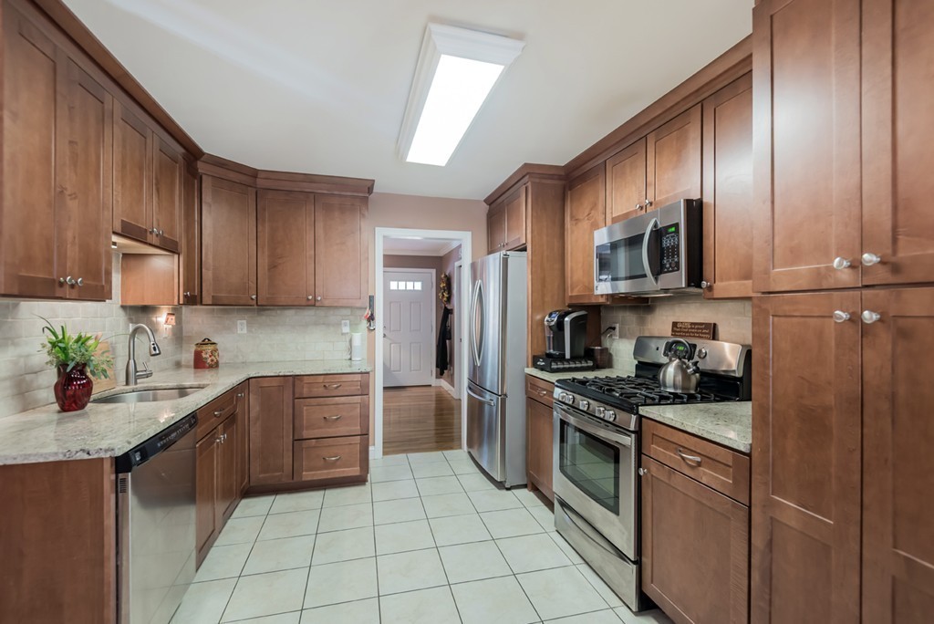 151 Killam Hill Road Boxford, MA 01921 - Photo 5 of 30 a kitchen with stainless steel appliances granite countertop a stove top oven a sink dishwasher and a refrigerator