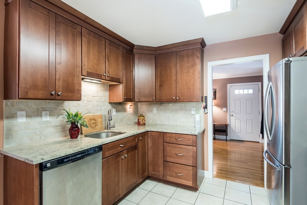151 Killam Hill Road Boxford, MA 01921 - Photo 6 of 30 a kitchen with a sink and wooden cabinets