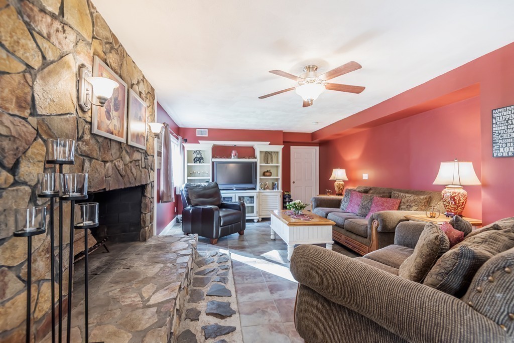 151 Killam Hill Road Boxford, MA 01921 - Photo 9 of 30 a living room with furniture a fireplace and a flat screen tv