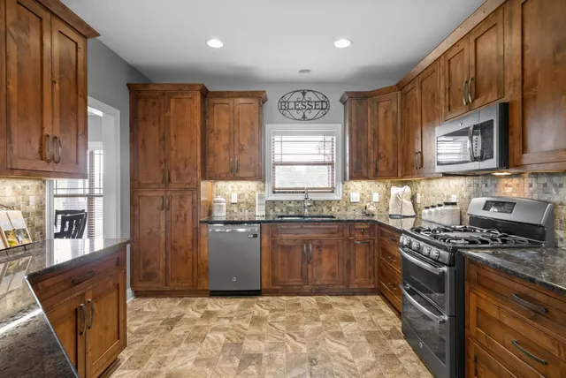 a dining room with furniture a chandelier and wooden floor