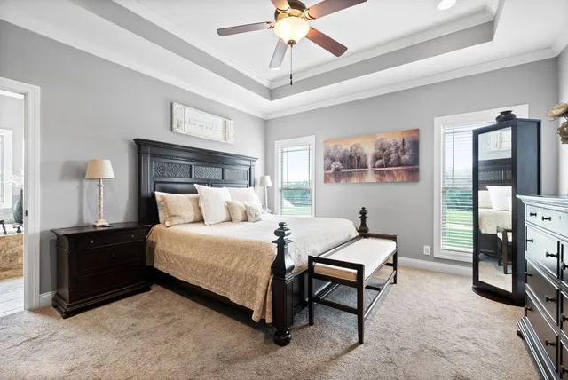 a bedroom with a bed couch and a window