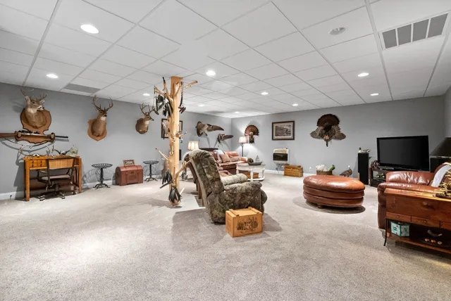 a view of a big house with a big yard and a large trees
