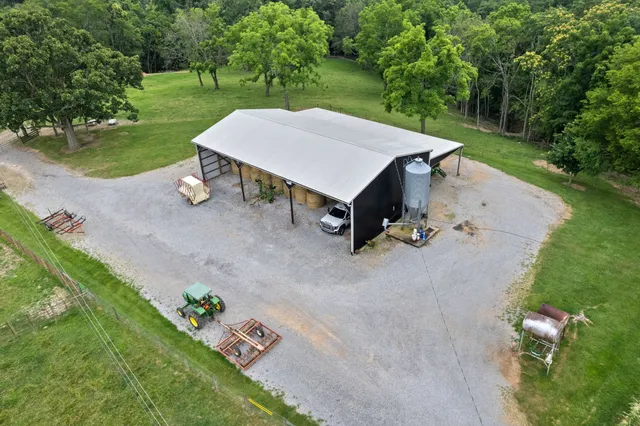 an aerial view of a residential houses with outdoor space and street view