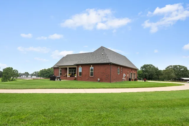 a front view of a house with yard and green space