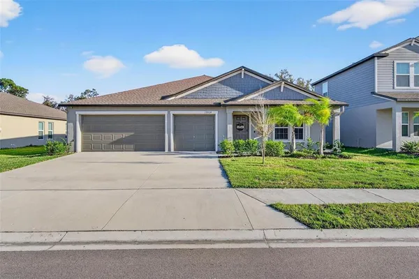 a front view of a house with a yard and garage