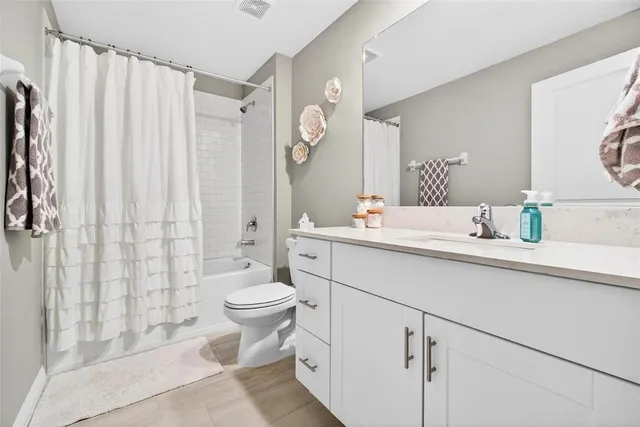 a bed room with a bed and a ceiling fan