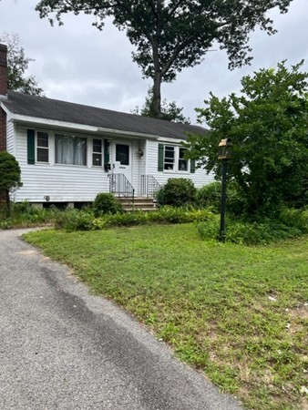 73 Whipple Road Billerica, MA 01821 - Photo 1 of 1 a front view of a house with a garden