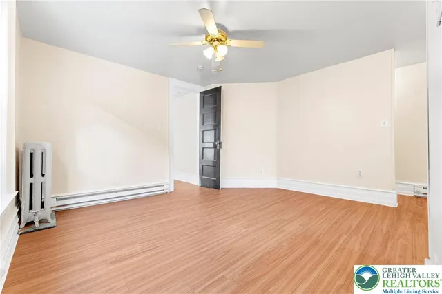 a large kitchen with stainless steel appliances granite countertop a sink and a wooden floors