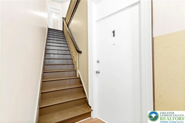 a kitchen with stainless steel appliances granite countertop a refrigerator a sink dishwasher a stove with wooden cabinets and floor