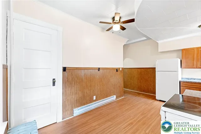 a kitchen with stainless steel appliances granite countertop a stove a sink dishwasher and a refrigerator with wooden floor