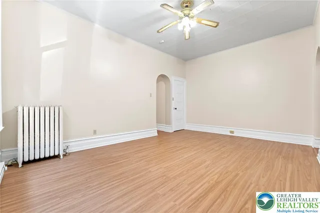 a white toilet sitting next to a bath tub