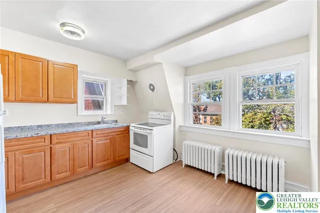 a bathroom with a granite countertop sink and a vanity