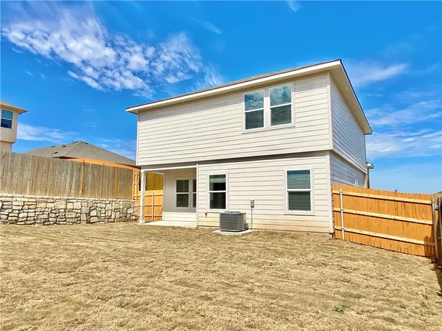a large white kitchen with a refrigerator a stove top oven a sink and a counter top space