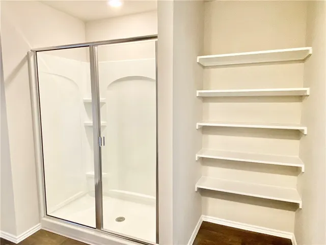 a bathroom with a sink a mirror and a shower