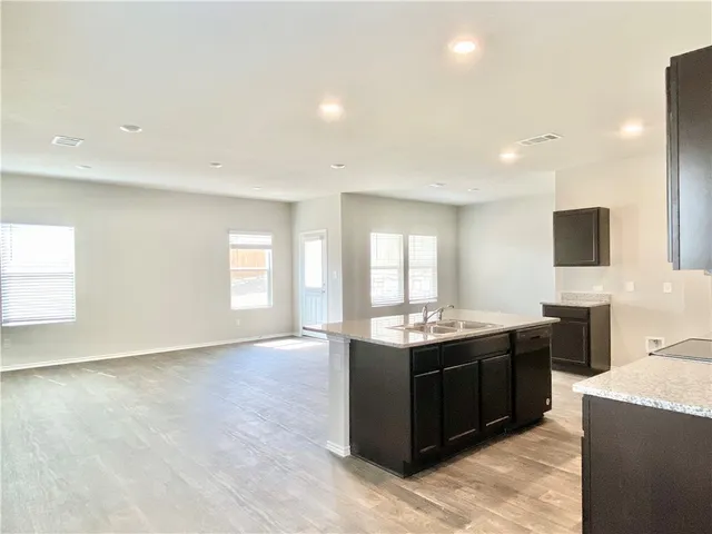 a kitchen with stainless steel appliances granite countertop a sink and a stove