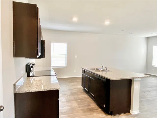 a kitchen with a sink and a mirror