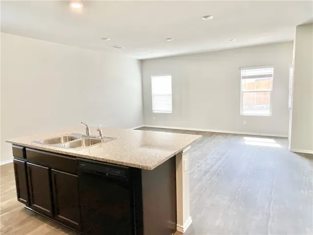 a kitchen with a sink cabinets and a window