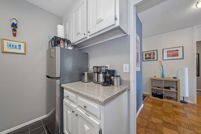 a kitchen with stainless steel appliances granite countertop a refrigerator and a stove