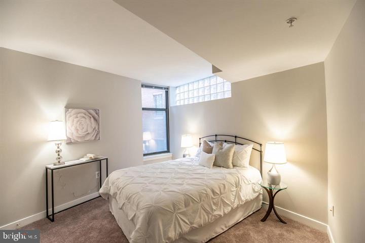 616 E Street Northwest, Unit 655 Washington, DC 20004 - Photo 11 of 38 a bedroom with a bed and a window