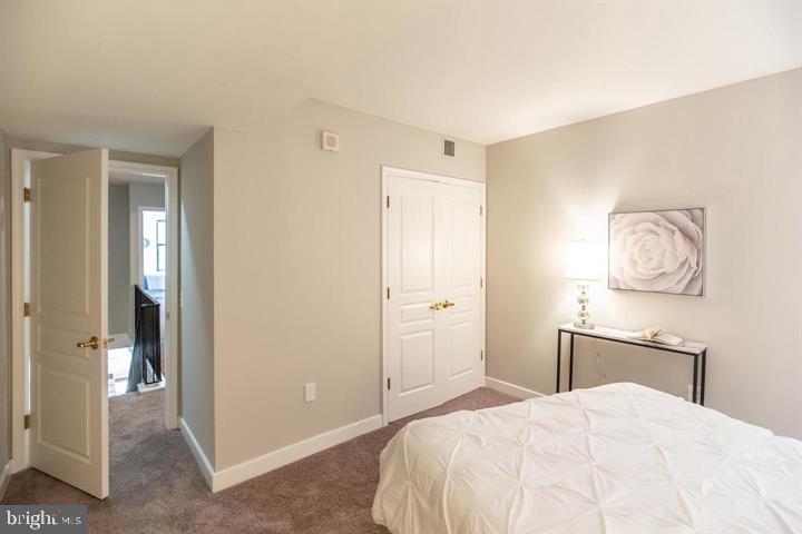 616 E Street Northwest, Unit 655 Washington, DC 20004 - Photo 12 of 38 a bedroom with a bed and a table in it