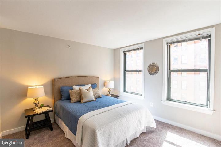 616 E Street Northwest, Unit 655 Washington, DC 20004 - Photo 17 of 38 a bedroom with a bed and a window