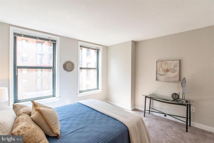 616 E Street Northwest, Unit 655 Washington, DC 20004 - Photo 18 of 38 a bedroom with a bed and a window