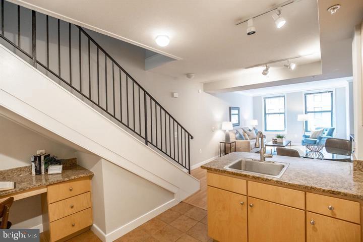 616 E Street Northwest, Unit 655 Washington, DC 20004 - Photo 3 of 38 a kitchen with sink cabinets and living room