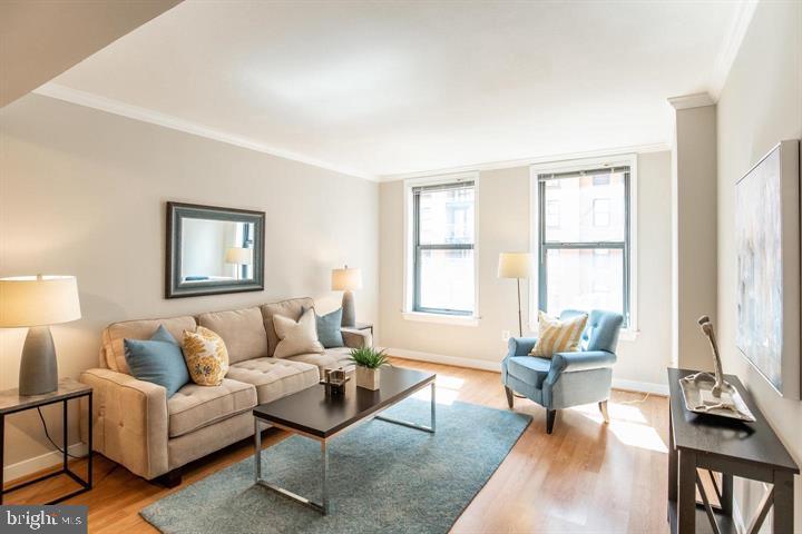 616 E Street Northwest, Unit 655 Washington, DC 20004 - Photo 4 of 38 a living room with furniture and a window