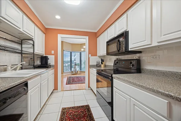 a kitchen with stainless steel appliances granite countertop a sink and a stove