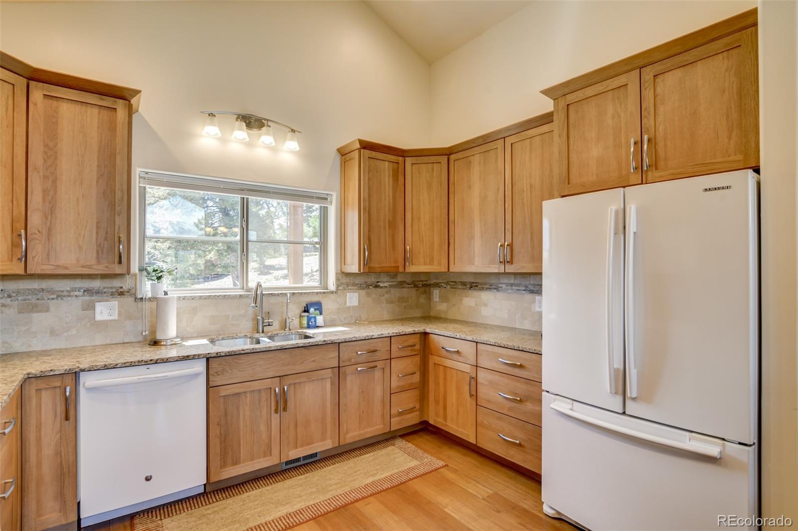 3900 Singletree Road Hartsel, CO 80449 - Photo 26 of 50 a kitchen with a refrigerator sink and cabinets